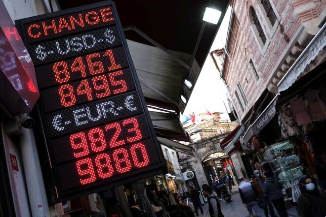 A board shows the currency exchange rates outside an exchange office in Istanbul