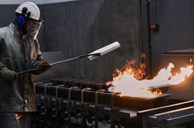 An employee casts ingots of 99.99 percent pure gold at the Krastsvetmet non-ferrous metals plant in Krasnoyarsk