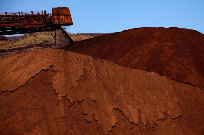 A stacker unloads iron ore onto a pile at a mine located in the Pilbara region of Western Australia