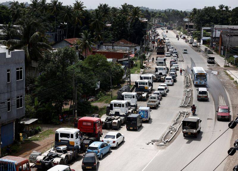 Vehicles queue for diesel and petrol as they wait for a bowser, in Colombo