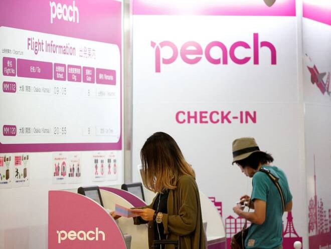 Passengers use Peach Aviation's check-in machines at New Tokyo international airport in Narita