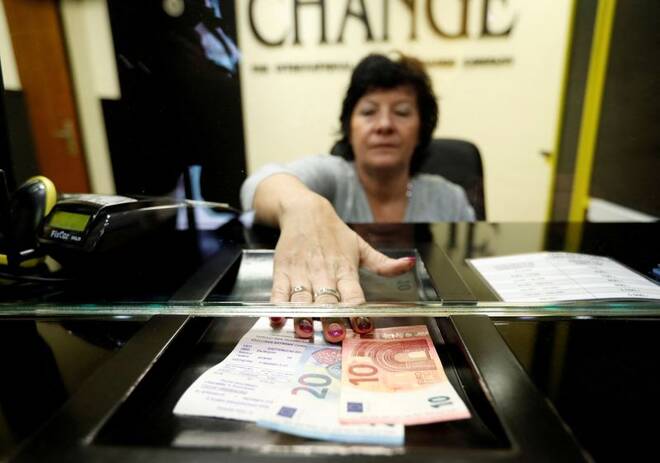 Woman exchanges forints for euros at currency exchange shop in Esztergom