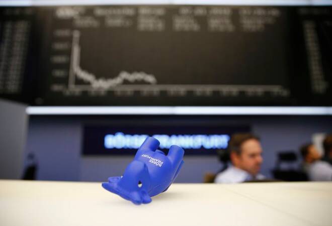 A styrofoam bull figure lies on its side in front of DAX board at Frankfurt's stock exchange