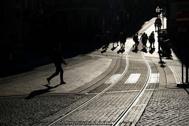 People cross a street in downtown Porto