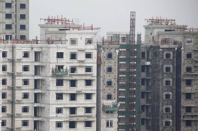 Men work at a construction site of residential apartment blocks in Beijing