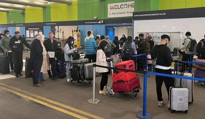 Passengers queue for check in outside Terminal 1 at Manchester Airport