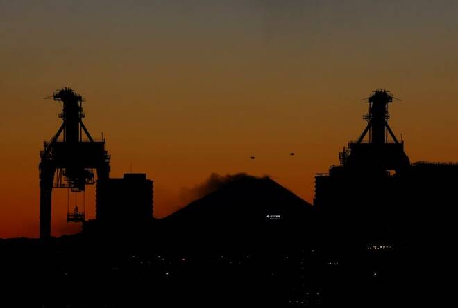 Cranes at an industrial port are seen in front of Mount Fuji in Tokyo