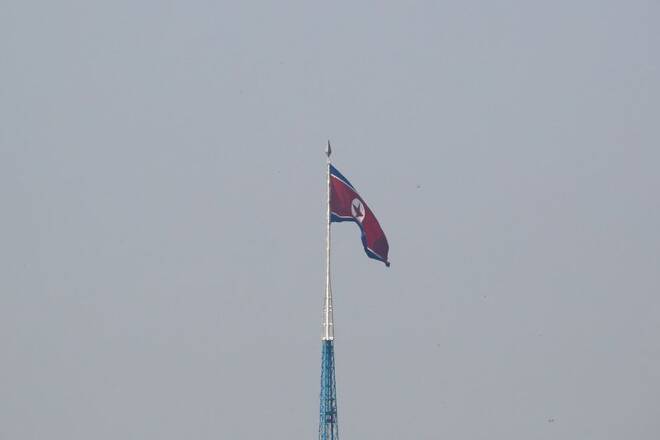 A North Korean flag flutters on top of a tower at North Korea's propaganda village of Gijungdong, as seen from Paju