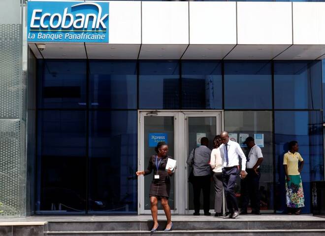 People walk at the entrance of Ecobank building in Abidjan