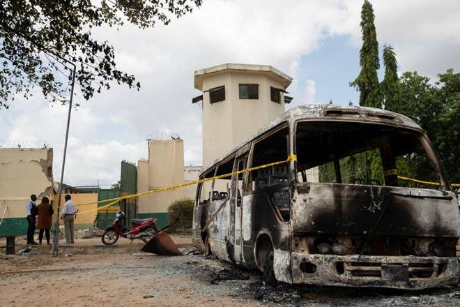 A burnt vehicle stands in front of the entrance of the medium-security prison after the attack by several gunmen in Kuje