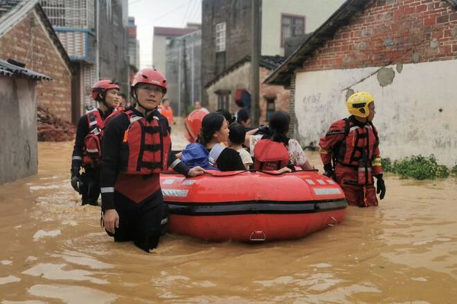 Rescue workers evacuate flood-affected residents after heavy rainfall brought by Typhoon Chaba, in Beihai