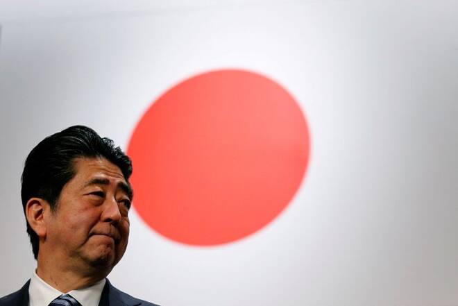 Japan's Prime Minister Abe stands in front of Japan's national flag after his ruling LDP annual party convention in Tokyo