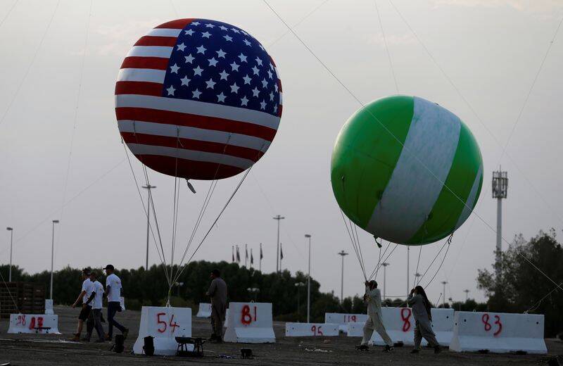 Workers are seen near a balloon with a United States flag on it as part of welcome celebrations ahead of the visit of U.S. President Donald Trump to Saudi Arabia, in Riyadh