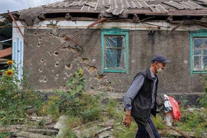 Local resident Vladimir Odarchenko walks past his house damaged during Ukraine-Russia conflict in the town of Popasna