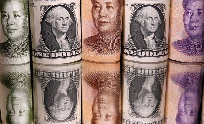 Chinese Yuan and U.S. dollar banknotes are seen in this illustration