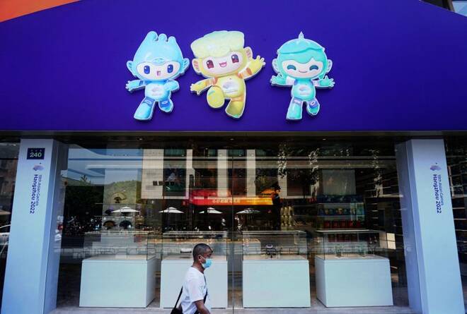 Person wearing a protective mask walks past a souvenir store for the 19th Asian Games Hangzhou 2022, amid the coronavirus disease (COVID-19) outbreak, in Hangzhou