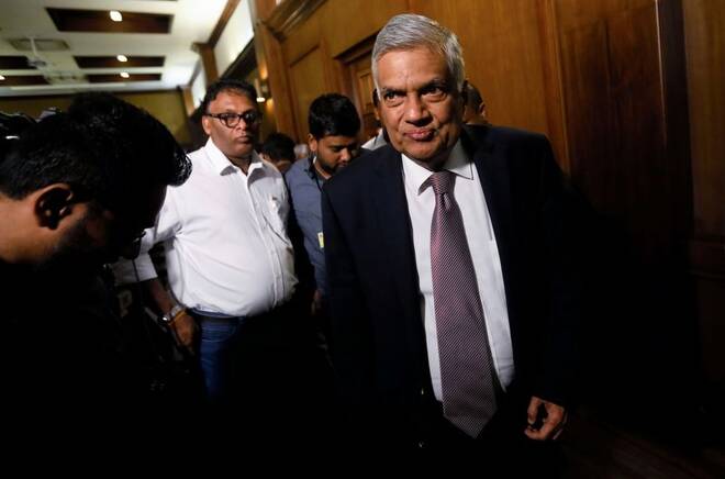 Sri Lankan Prime Minister Ranil Wickremesinghe leaves after a news conference in Colombo