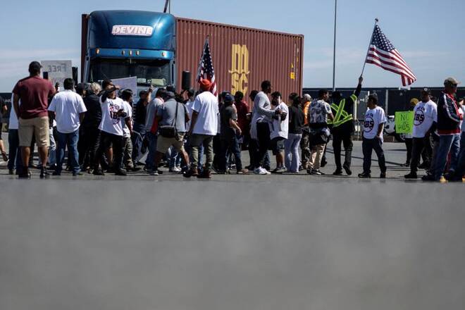 Independent truck drivers gather to delay the entry of trucks at a container terminal at the Port of Oakland, during a protest against California's law known as AB5, in Oakland, California