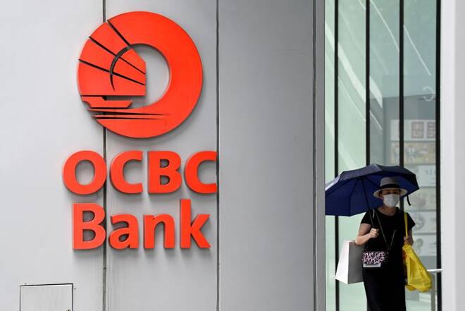 Woman walks by an OCBC signage in Singapore