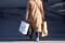 A shopper carries bags after the Swiss government relaxed some of its COVID-19 restrictions, in Zurich
