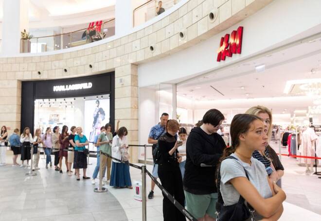 People line up to enter an H&M store in Moscow