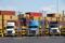 Trucks loaded with shipping containers leave the Port of Montreal