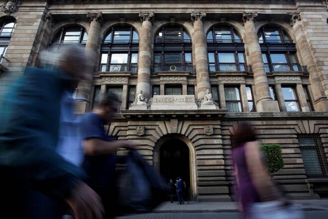 People walk past the building of Mexico's Central Bank (Banco de Mexico) in downtown Mexico City