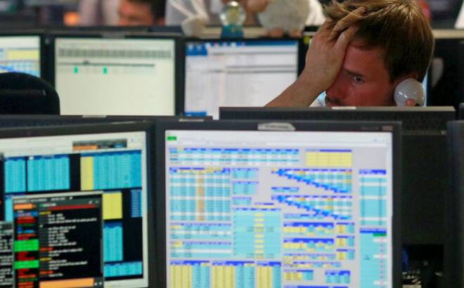 Traders from BGC, a global brokerage company in London's Canary Wharf financial centre react as European stock markets open