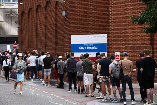 People queue up to receive monkeypox vaccinations during a pop-up clinic at Guy's Hospital in central London