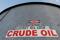 A sticker reads crude oil on the side of a storage tank in the Permian Basin