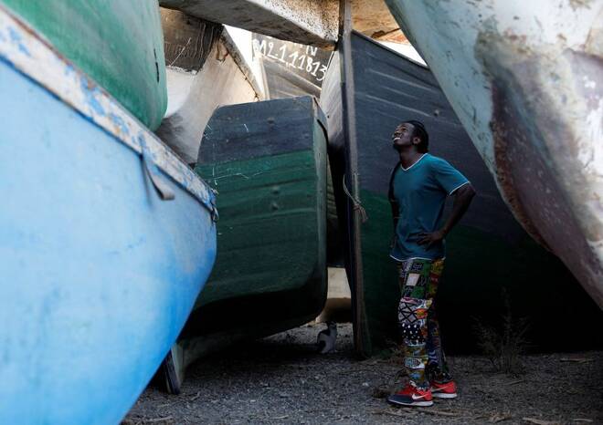 Mohamed Fane is seen in a cemetery of abandoned wooden boats in Arinaga