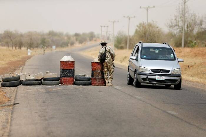 A soldier checks a vehicle at a military check point in Dapchi, Yobe state