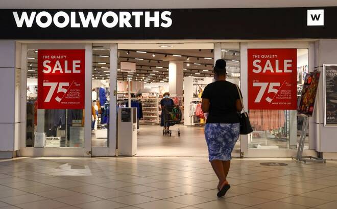 A shopper walks to a Woolworths store in Johannesburg