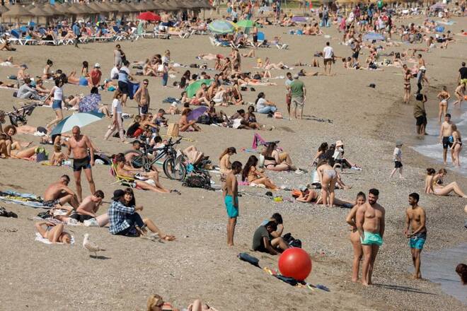 People enjoy the weather on a beach in Malaga