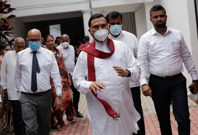 Basil Rajapaksa gestures as he leaves in Colombo