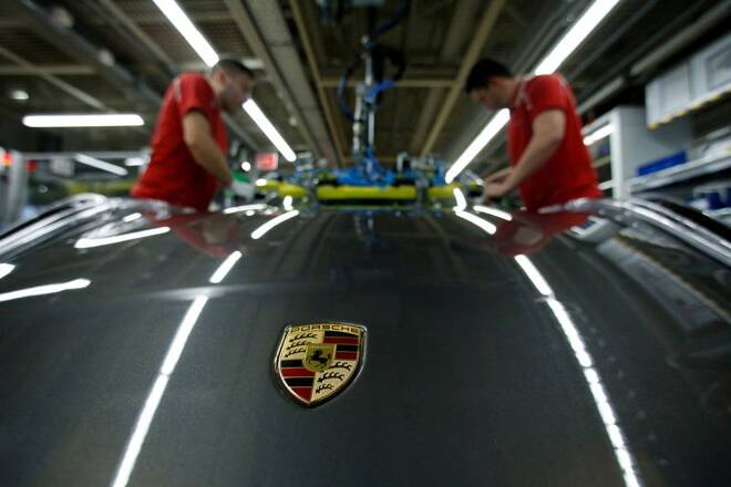 Employees of German car manufacturer Porsche install the windshield of a Porsche 911 at the Porsche factory in Stuttgart-Zuffenhausen