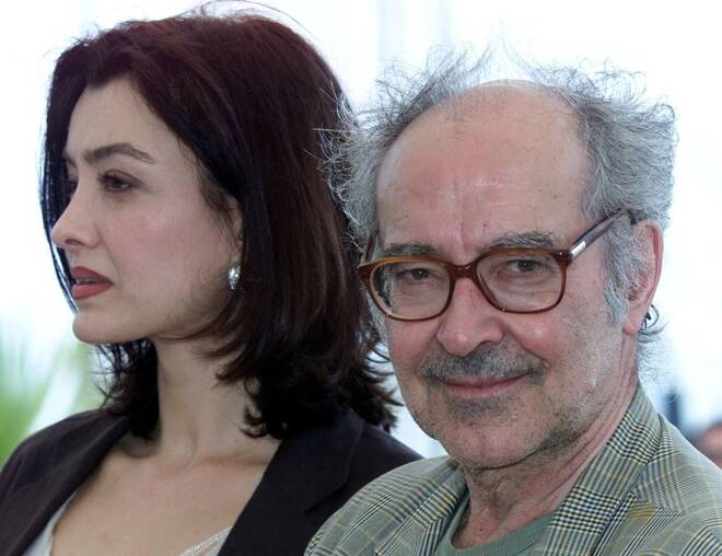 French-Swiss director Jean Luc Godard (R) smiles as he stands with actress Cecile Camp (L) for their film "..