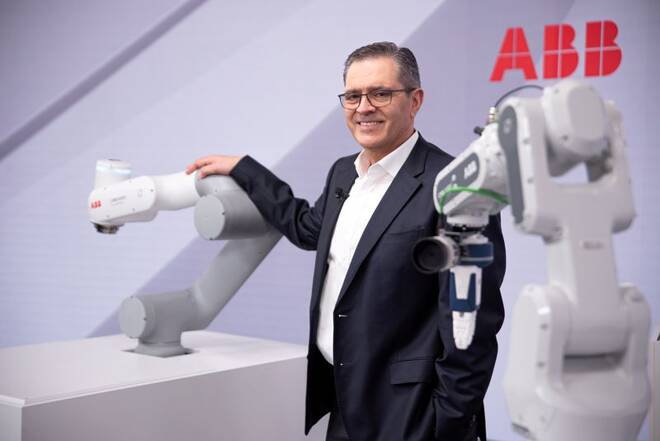Head of ABB Robotics and Discrete Automation business Sami Atiya poses next to robots in Zurich