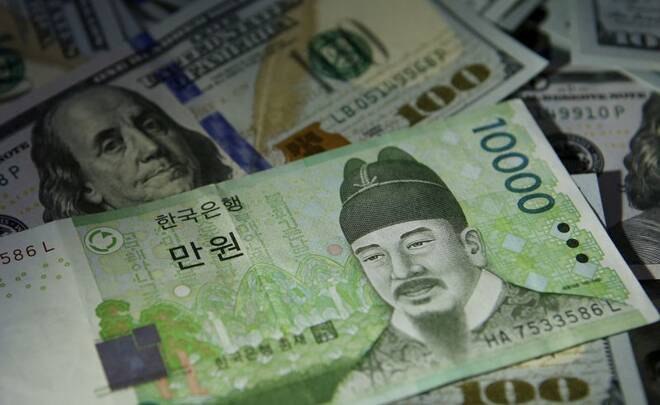South Korean 10,000 won note is seen on U.S. 100 dollar notes in this picture illustration taken in Seoul