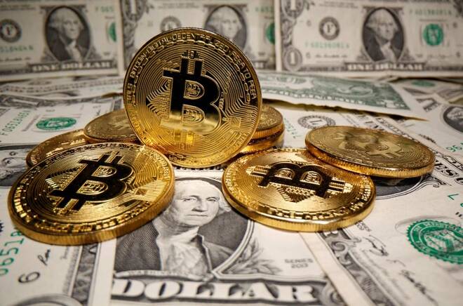 Representations of virtual currency Bitcoin are placed on U.S. Dollar banknotes