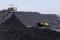 A truck drives past a conveyor pouring coal produced at Canyon Coal's Khanye colliery near Bronkhorstspruit, South Africa