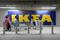 Shoppers push carts past a logo of IKEA outside IKEA's new store in Bengaluru