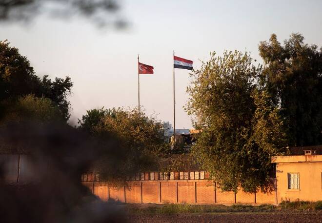 Syrian and Turkish flags flutter at the Turkish-Syrian border