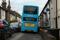 An Arriva bus makes its way down a narrow street