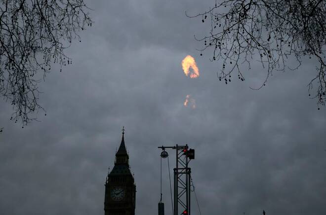 A fracking rig flares gas during an anti-fracking protest by Greenpeace activists outside the Houses of Parliament in London