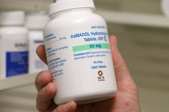 A pharmacists holds a bottle of traMADOL Hydrochloride made by Sun Pharma at a pharmacy, in Provo, Utah