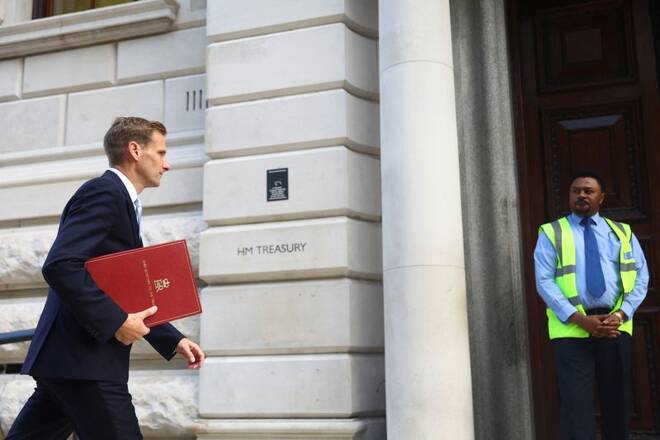 Chief Secretary to the Treasury Chris Philp walks outside Treasury building, in London