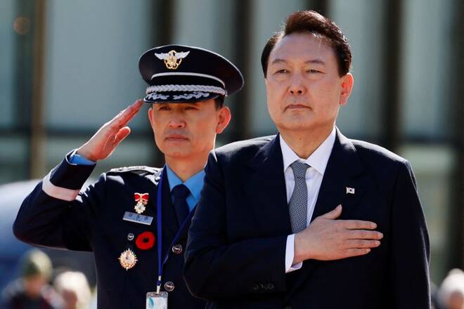 South Korean President Yoon Suk-yeol takes part in a wreath laying ceremony at the National War Memorial in Ottawa