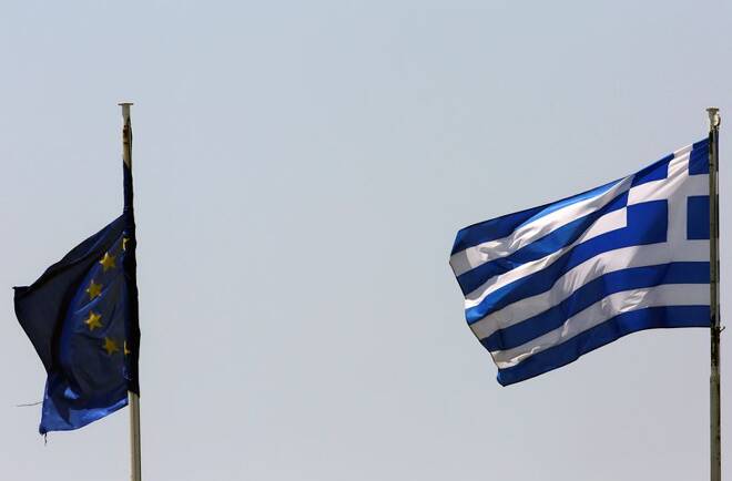 A Greek and an EU flag fluter atop Greece's financial ministry in Athens