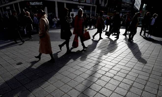People carry bags along a shopping street in the centre of Liverpool